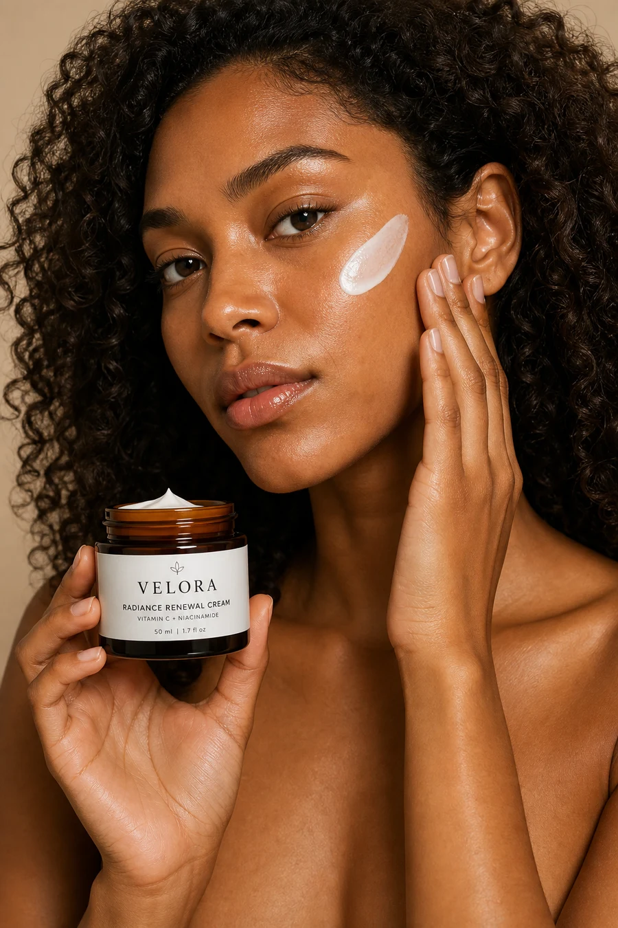 Black woman holding a Velora skincare jar with cream on her cheek