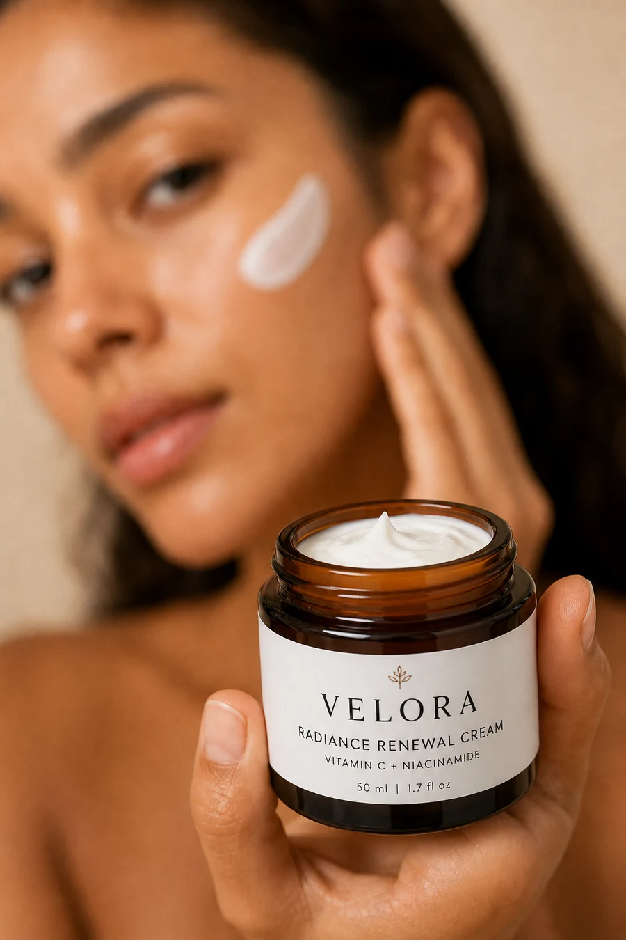 Velora skincare jar in focus with model softly blurred behind